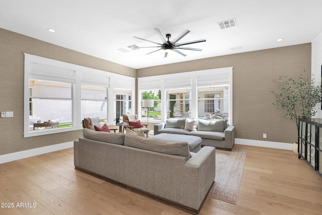 3173 E Page Ave, Gilbert, AZ 85234 - living room with visible vents, baseboards, a ceiling fan, and light wood-style flooring