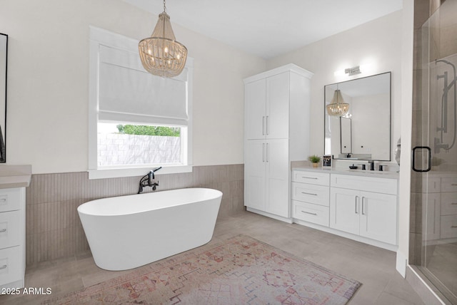 3173 E Page Ave, Gilbert, AZ 85234 - bathroom featuring an inviting chandelier, vanity, and a stall shower