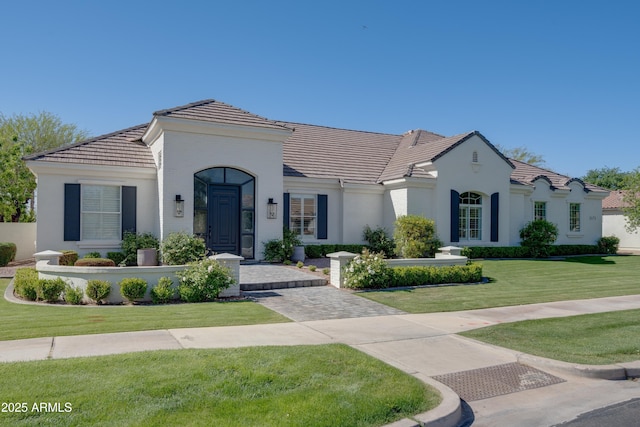 3173 E Page Ave, Gilbert, AZ 85234 - mediterranean / spanish house featuring a tiled roof, stucco siding, and a front lawn