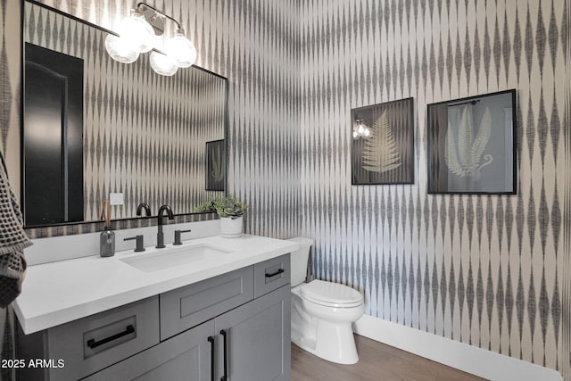 3173 E Page Ave, Gilbert, AZ 85234 - bathroom featuring a notable chandelier, vanity, wallpapered walls, toilet, and wood finished floors