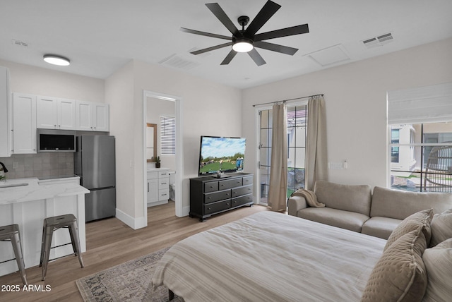 3173 E Page Ave, Gilbert, AZ 85234 - bedroom featuring baseboards, light wood-style flooring, freestanding refrigerator, visible vents, and a sink