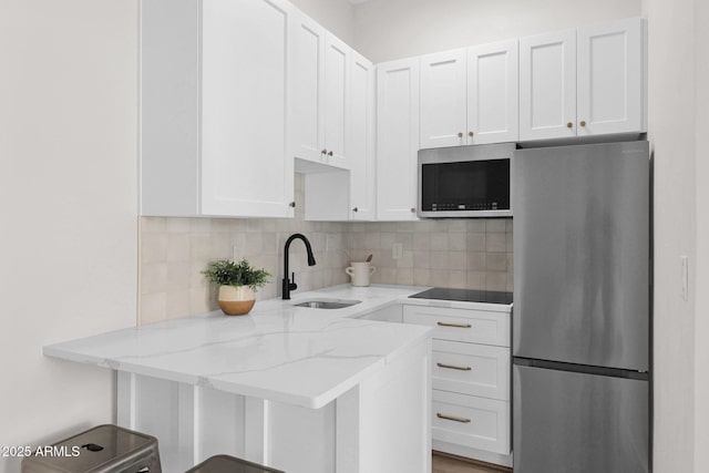 3173 E Page Ave, Gilbert, AZ 85234 - kitchen featuring tasteful backsplash, white cabinetry, light stone countertops, stainless steel appliances, and a sink