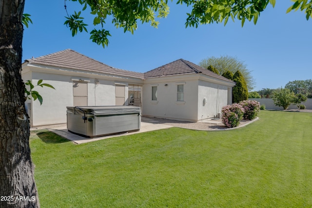 3173 E Page Ave, Gilbert, AZ 85234 - rear view of property with a hot tub, a patio area, a lawn, a tile roof, and stucco siding