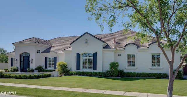 3173 E Page Ave, Gilbert, AZ 85234 - view of front facade with a tile roof, stucco siding, and a front lawn