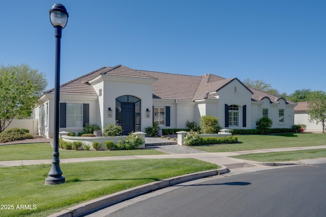 3173 E Page Ave, Gilbert, AZ 85234 - mediterranean / spanish-style house featuring a front lawn, stucco siding, and a tile roof
