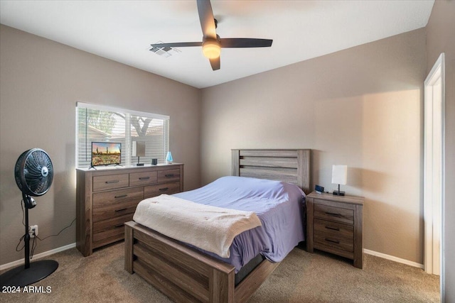 bedroom with ceiling fan, light colored carpet, and vaulted ceiling