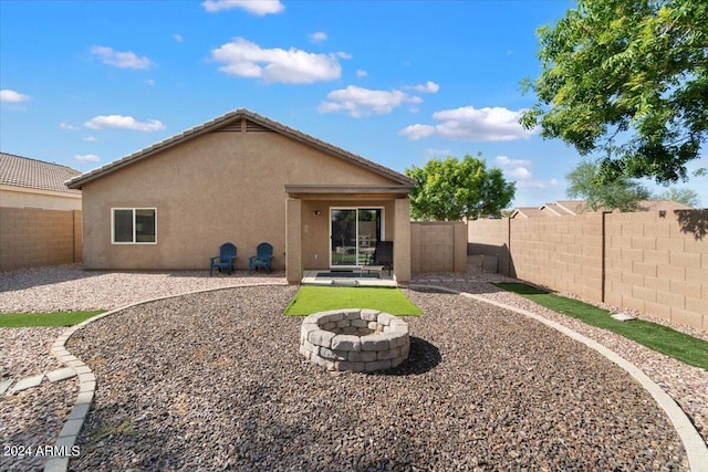 back of house featuring a patio area and a fire pit