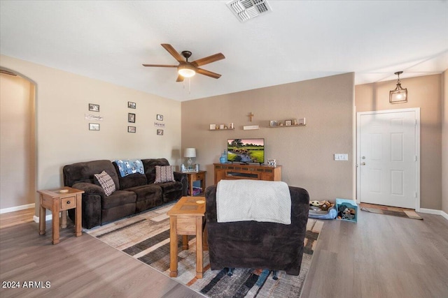 living room featuring ceiling fan and hardwood / wood-style floors