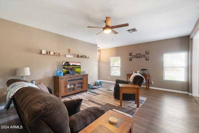 living room featuring hardwood / wood-style flooring and ceiling fan