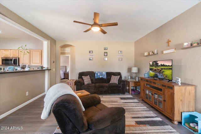 living room featuring hardwood / wood-style flooring and ceiling fan