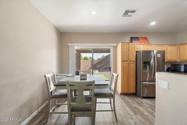 dining space with light hardwood / wood-style floors