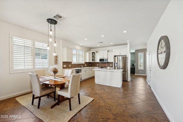 dining space featuring baseboards, visible vents, and recessed lighting