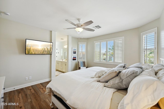 bedroom with ceiling fan, dark wood-style flooring, visible vents, baseboards, and ensuite bath