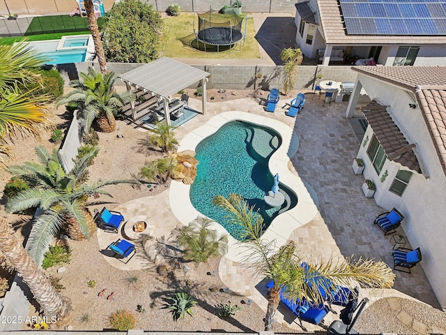 view of swimming pool featuring a fenced backyard, a trampoline, a fenced in pool, and a patio