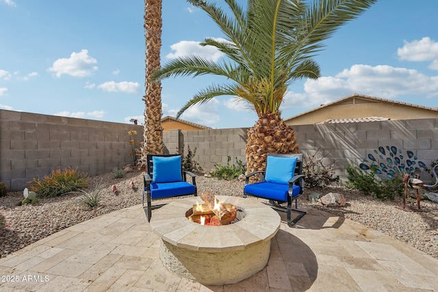 view of patio featuring an outdoor fire pit and a fenced backyard