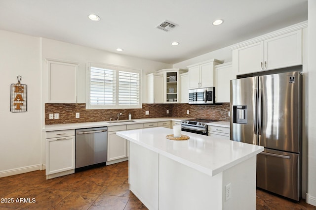 kitchen with visible vents, appliances with stainless steel finishes, backsplash, and a sink