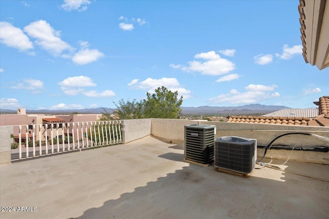 view of patio / terrace featuring a mountain view and central AC unit