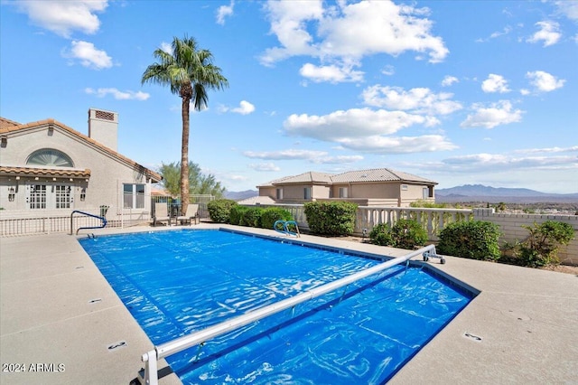 view of swimming pool featuring a mountain view and a patio area