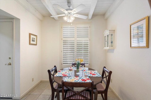 dining room featuring ceiling fan, beamed ceiling, wood ceiling, and light tile patterned floors