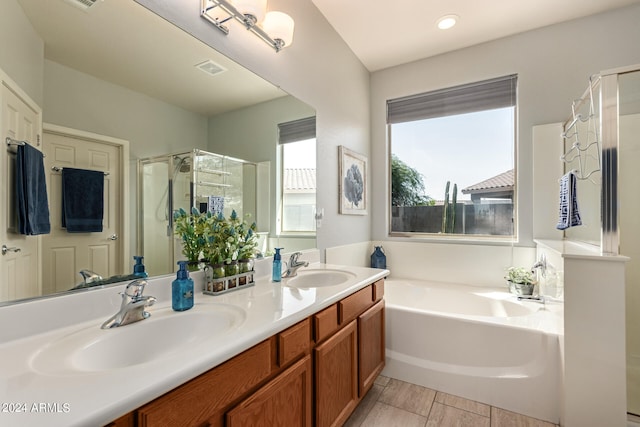 bathroom with independent shower and bath and vanity