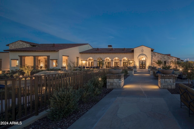 mediterranean / spanish home featuring a patio area