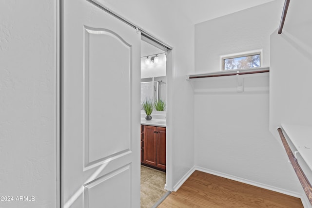 walk in closet featuring light wood finished floors