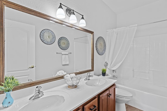 full bath with toilet, double vanity, a sink, and  shower combination