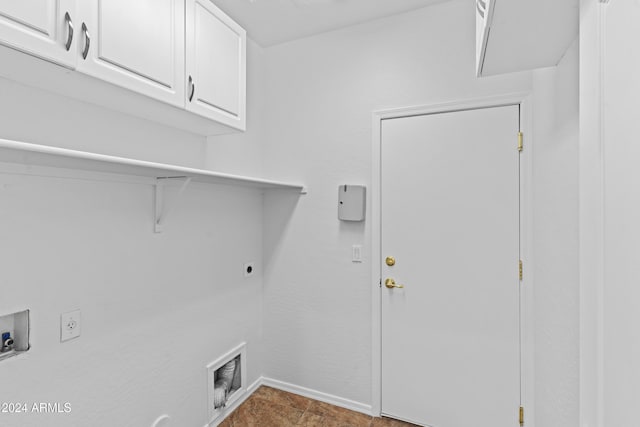 clothes washing area featuring baseboards, cabinet space, hookup for an electric dryer, and washer hookup