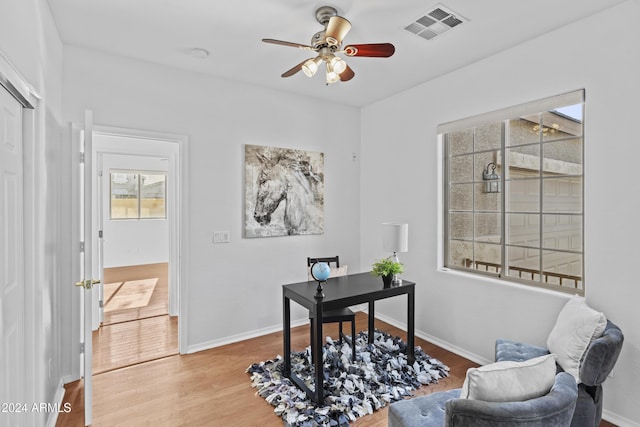 office featuring visible vents, wood finished floors, and a healthy amount of sunlight