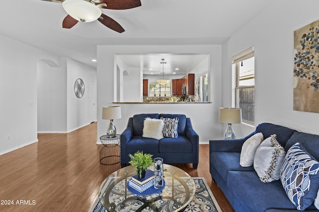 living area with baseboards, recessed lighting, wood finished floors, and ceiling fan
