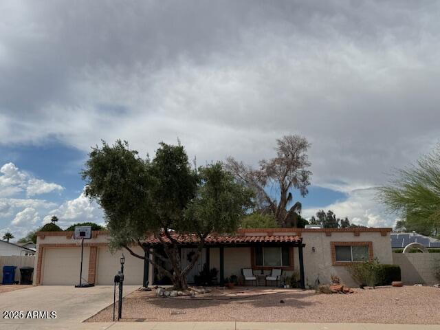 1046 E Fairfield St, Mesa, AZ 85203 - view of front of house with a garage, driveway, and stucco siding