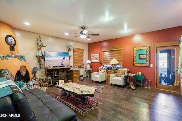 living room with dark hardwood / wood-style flooring and ceiling fan