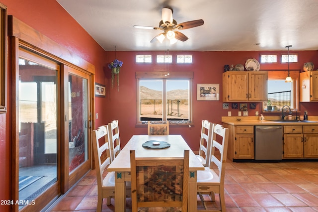 dining space with ceiling fan, a mountain view, light tile patterned floors, and sink