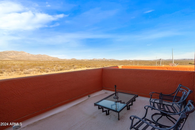 view of patio / terrace with a mountain view and a balcony