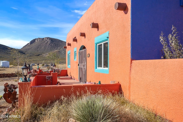 view of side of home with a mountain view