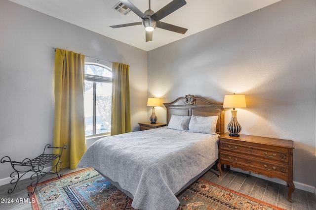 bedroom with dark wood-type flooring and ceiling fan