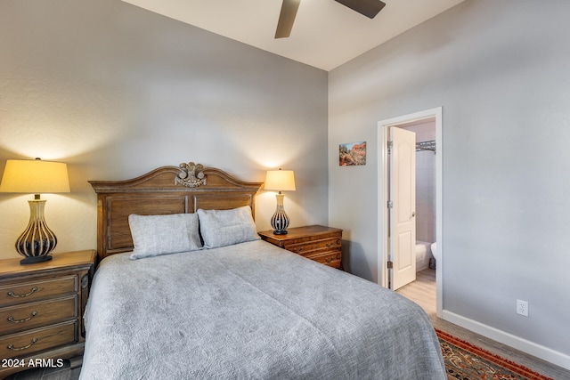 bedroom with ceiling fan, light hardwood / wood-style floors, and ensuite bath