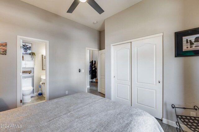 bedroom with a closet, hardwood / wood-style floors, ceiling fan, and ensuite bath