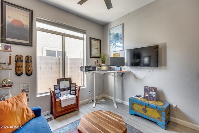 living room with light wood-type flooring and ceiling fan