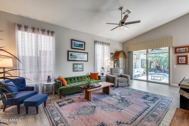 living room with ceiling fan, lofted ceiling, hardwood / wood-style floors, and a healthy amount of sunlight