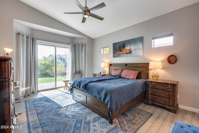 bedroom featuring multiple windows, lofted ceiling, ceiling fan, and light hardwood / wood-style flooring