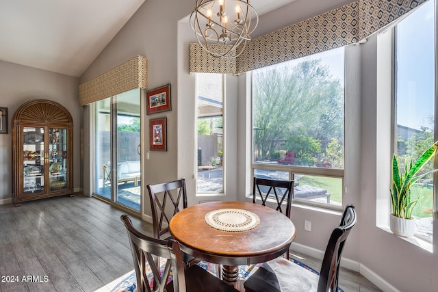 dining area featuring a wealth of natural light, wood-type flooring, and an inviting chandelier