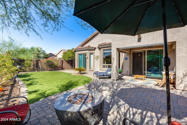 back of house featuring a lawn and a patio area