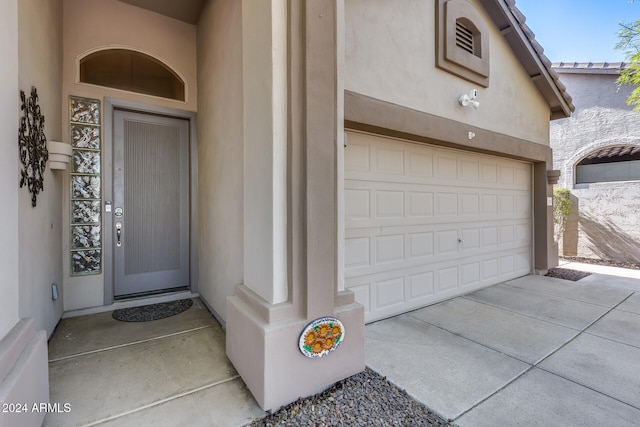 view of exterior entry featuring a garage