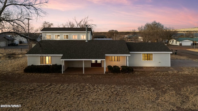 view of back house at dusk