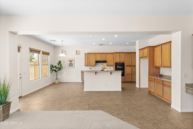 kitchen with brown cabinetry, recessed lighting, dobule oven black, and baseboards