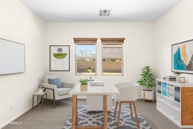 office area with carpet floors, visible vents, and baseboards