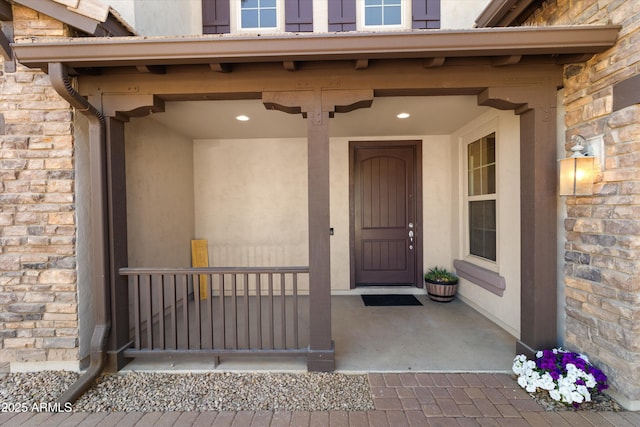 entrance to property featuring stone siding and brick siding