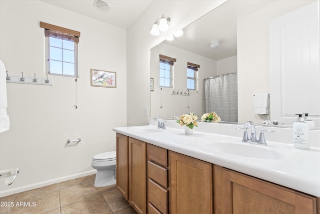 full bathroom with toilet, plenty of natural light, and a sink