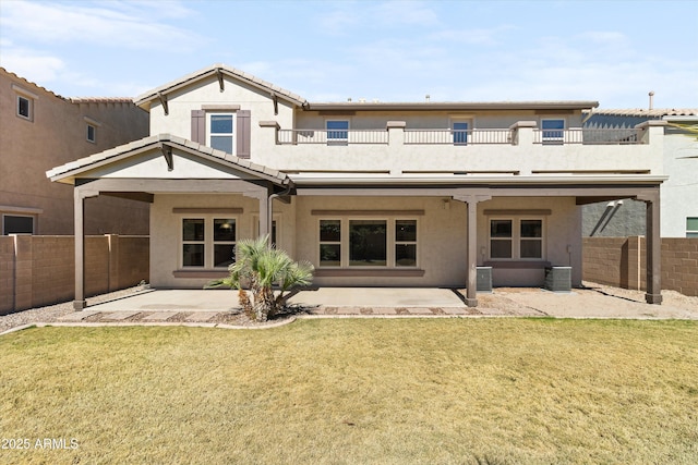 rear view of property with a patio, fence, a balcony, and stucco siding